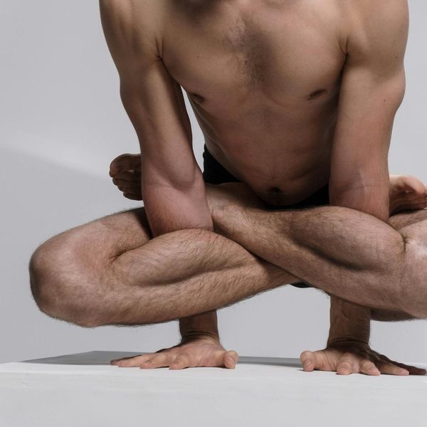 A man focused on his posture during a complex bodyweight exercise.